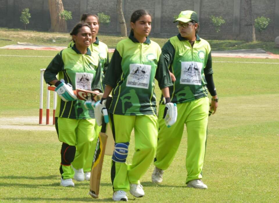 The Pakistan women's blind cricket players walk off the ground after a batting excursion
