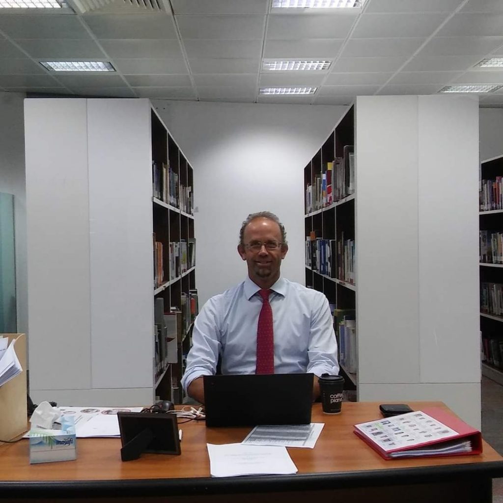 Gerry Gibson behind the desk.