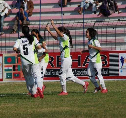 Pakistan women's football team celebrates a goal 