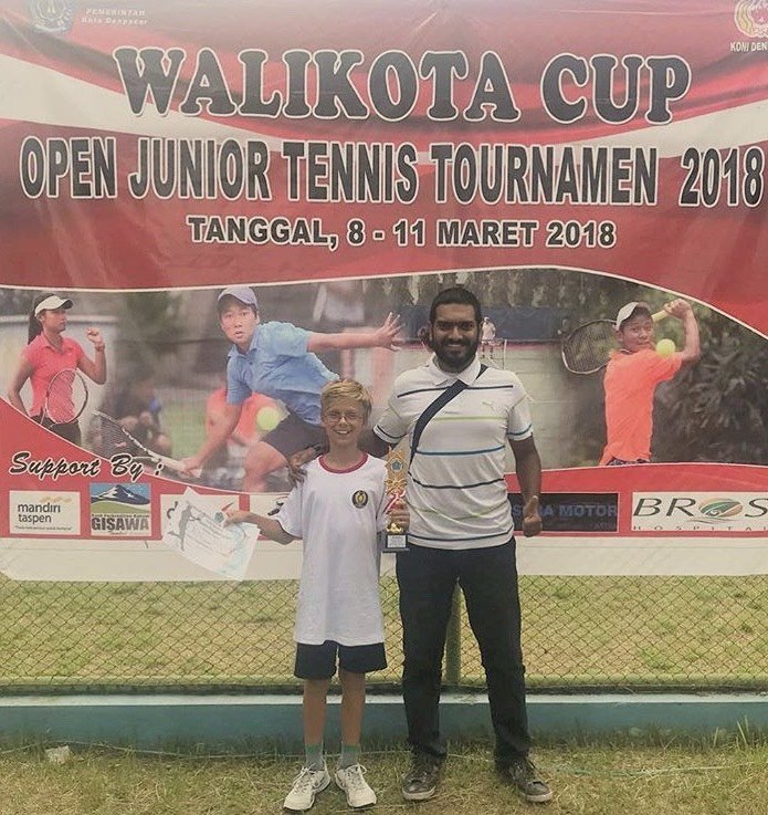zamir mohamed yacob with a young boy during junior tennis tournament