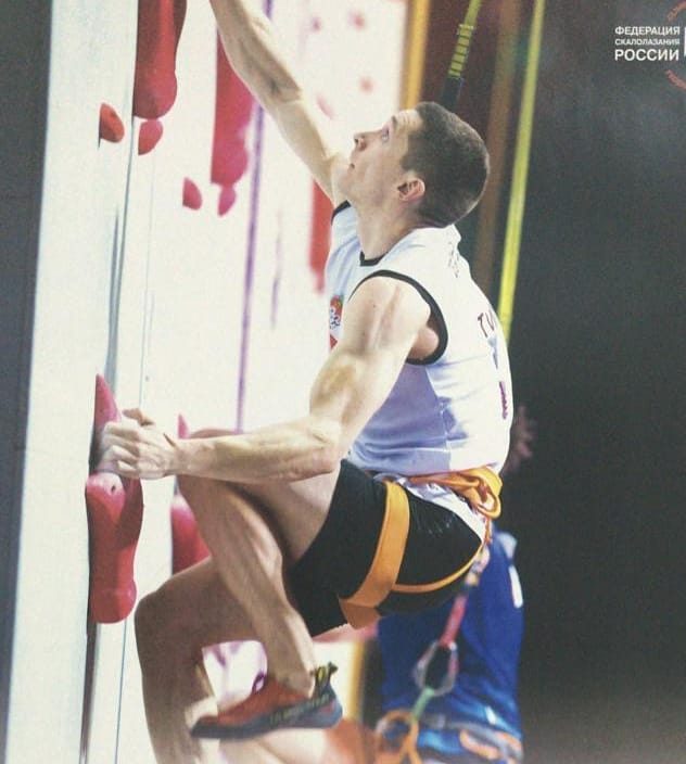 male climber on boulder indoor climbing wall