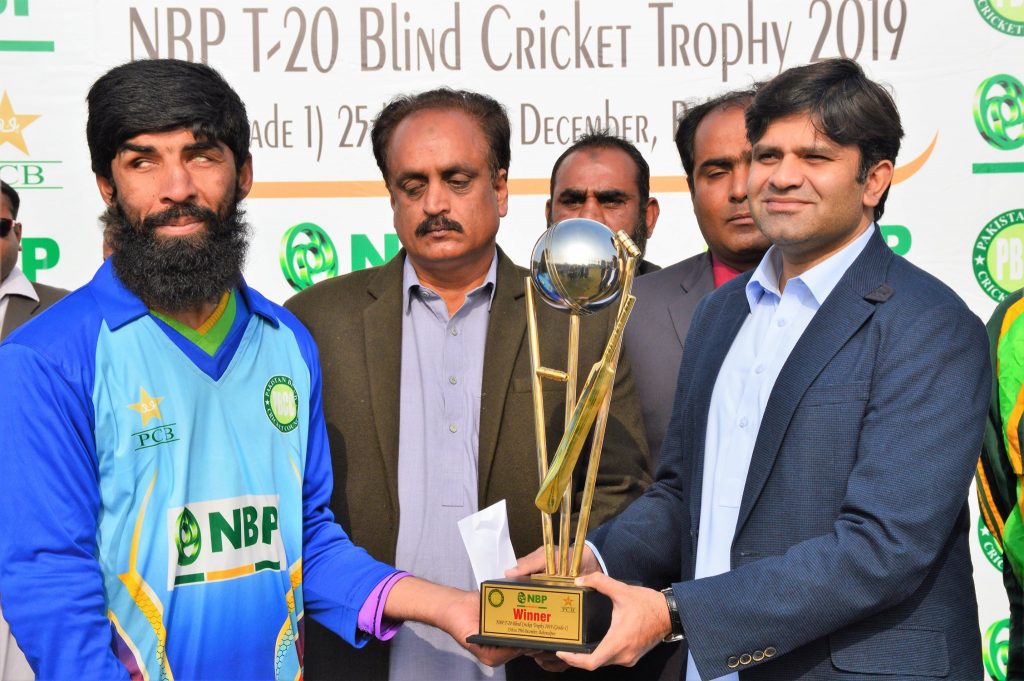 sultan shah gives a trophy to the winning captain of the NBP T-20 Blind Cricket Trophy 2019