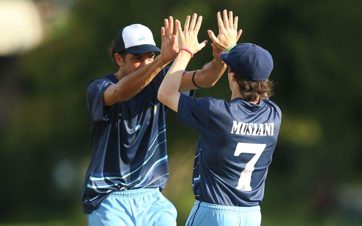 Lautaro Musiani congratulating his teammate after a cricket wicket