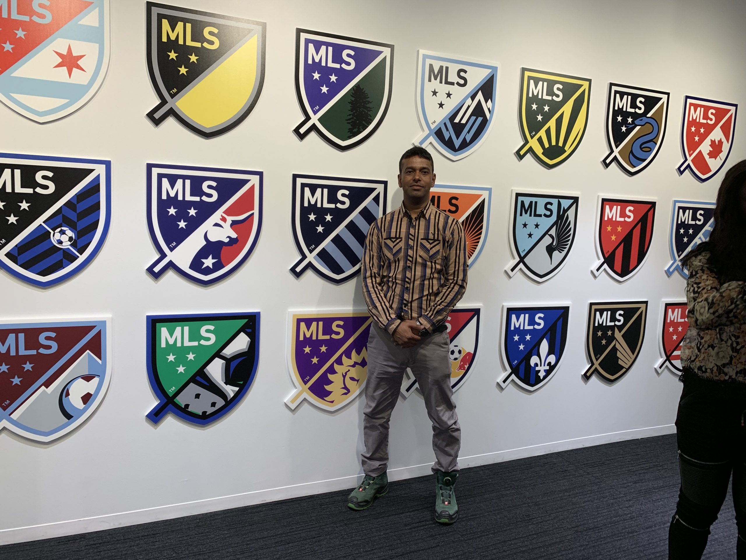 KT standing infront of MLS clubs logo (nepal football)