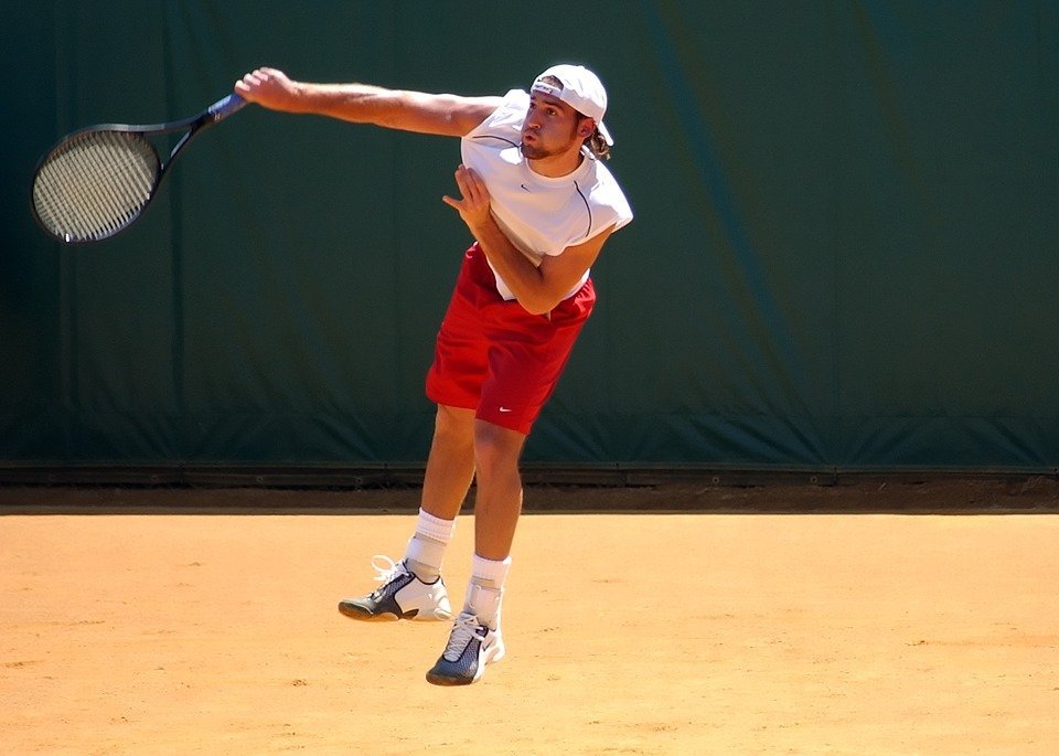 male tennis player hitting a shot