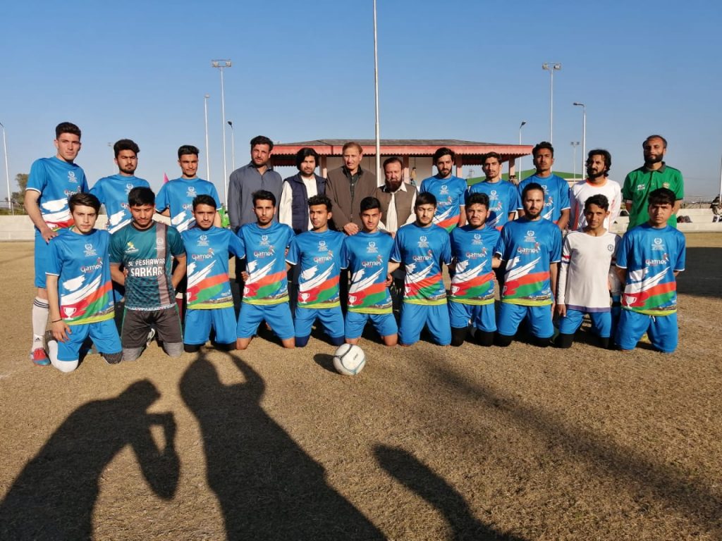Furqan Ahmad with his teammates and coach football in Charsadda