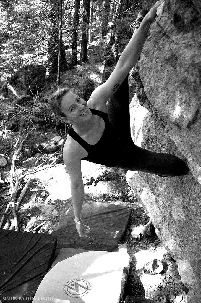 Tiffany is climbing on a rock.