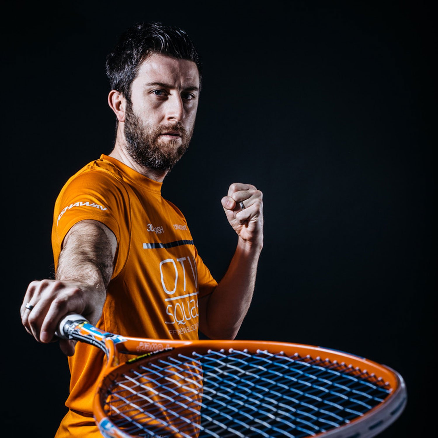 Daryl Selby poses with a Squash racket