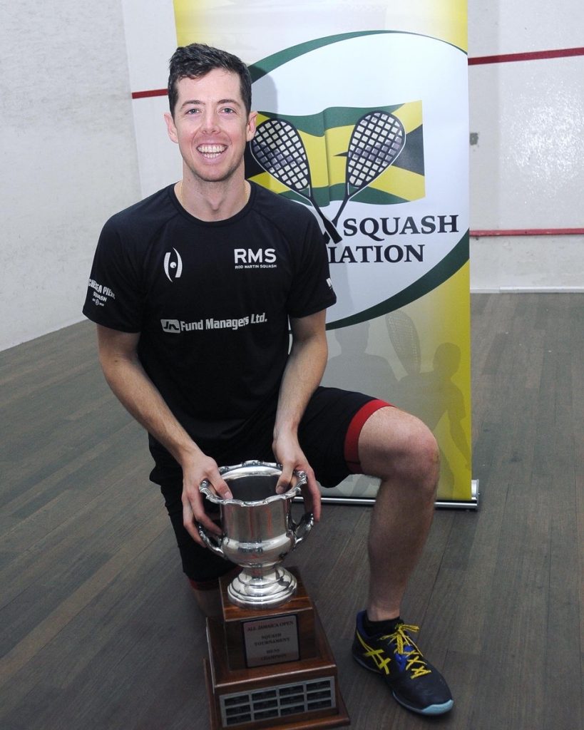 Jamaica squash star, Chris Binnie poses with a trophy