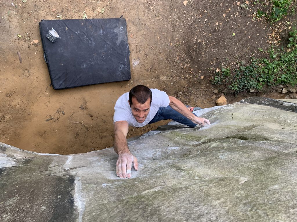 Remi Samyn, French national coach, climbs a boulder