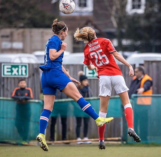 Lois Heuchan of Charlton Athletic Football Club on a header battle against her opponent