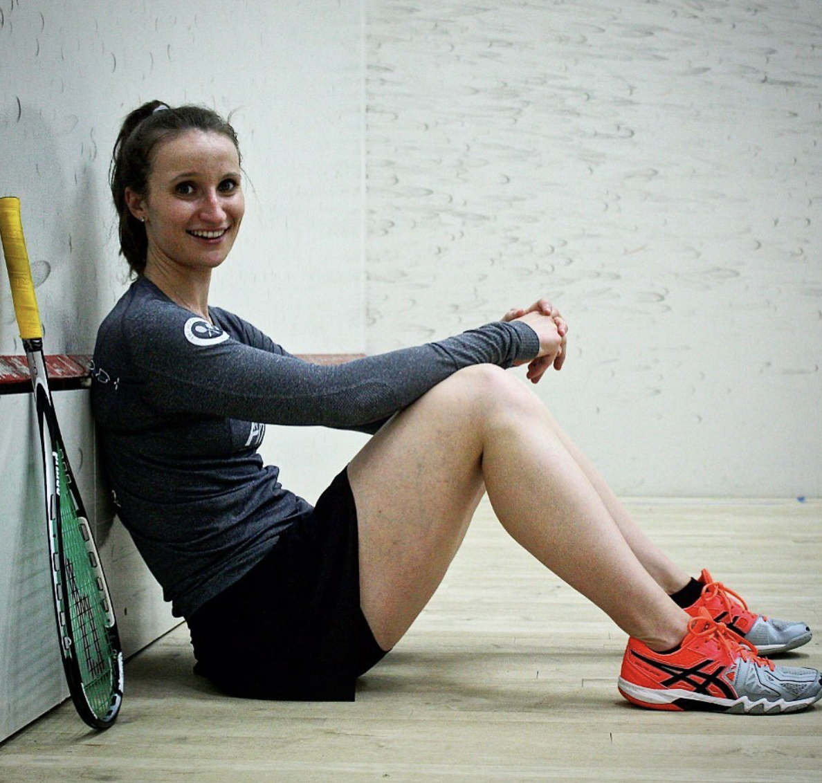 Haley Mendez sitting on the Squash Court