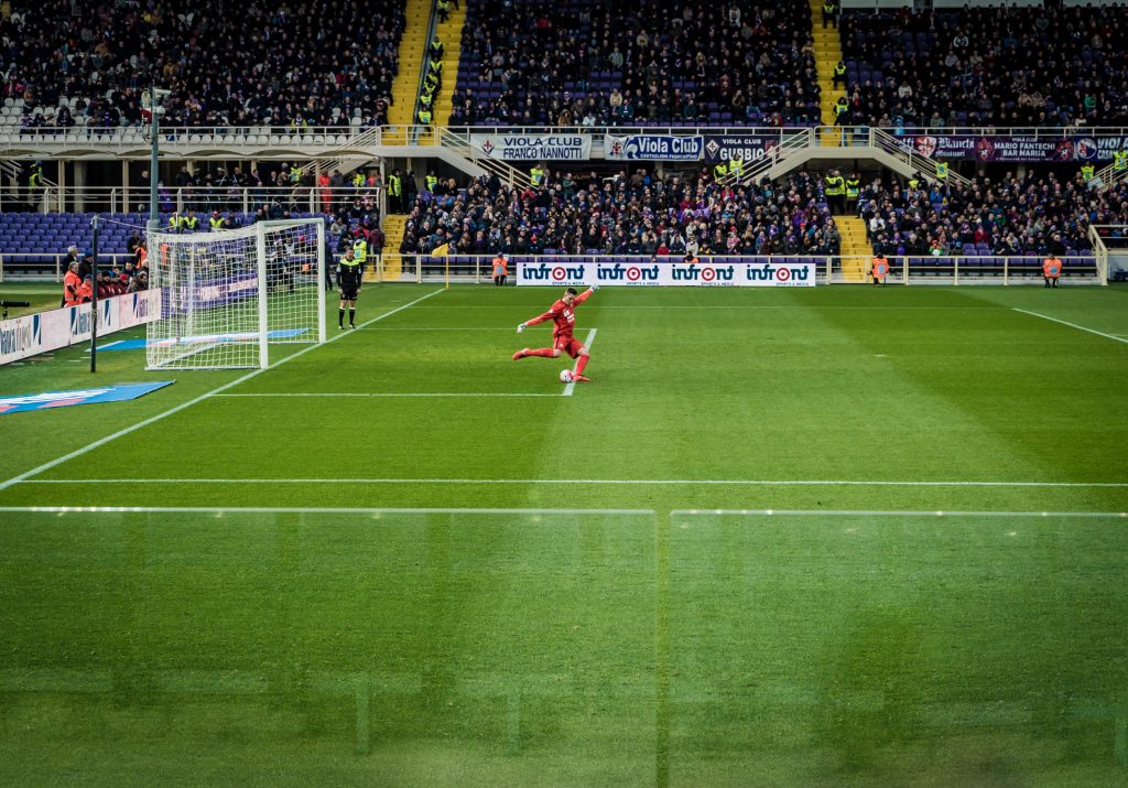 A goal keeper kicks the ball